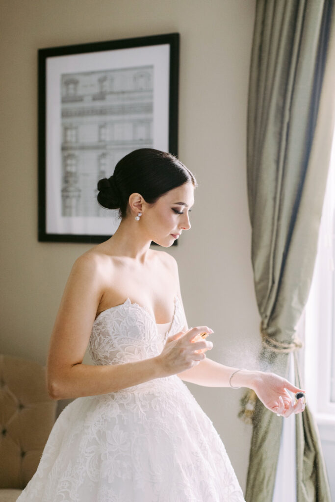 Philadelphia bride spraying her wedding day perfume by Emily Wren Photography