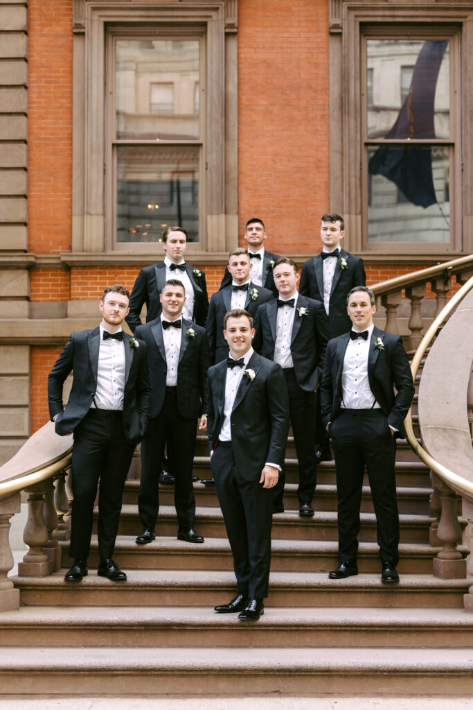 Philadelphia groom with his groomsmen on the stairs of the Union League in Center City