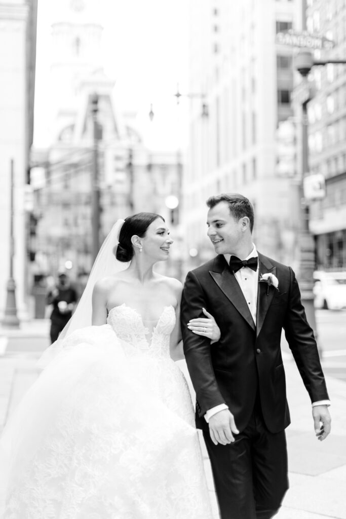 Philadelphia bride & groom walking through Center City by Emily Wren Photography