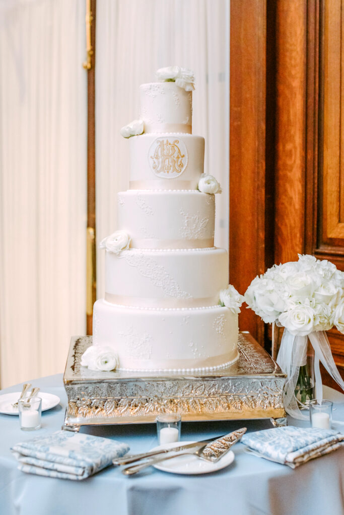 5 tier wedding cake with gold wedding crest by Emily Wren Photography