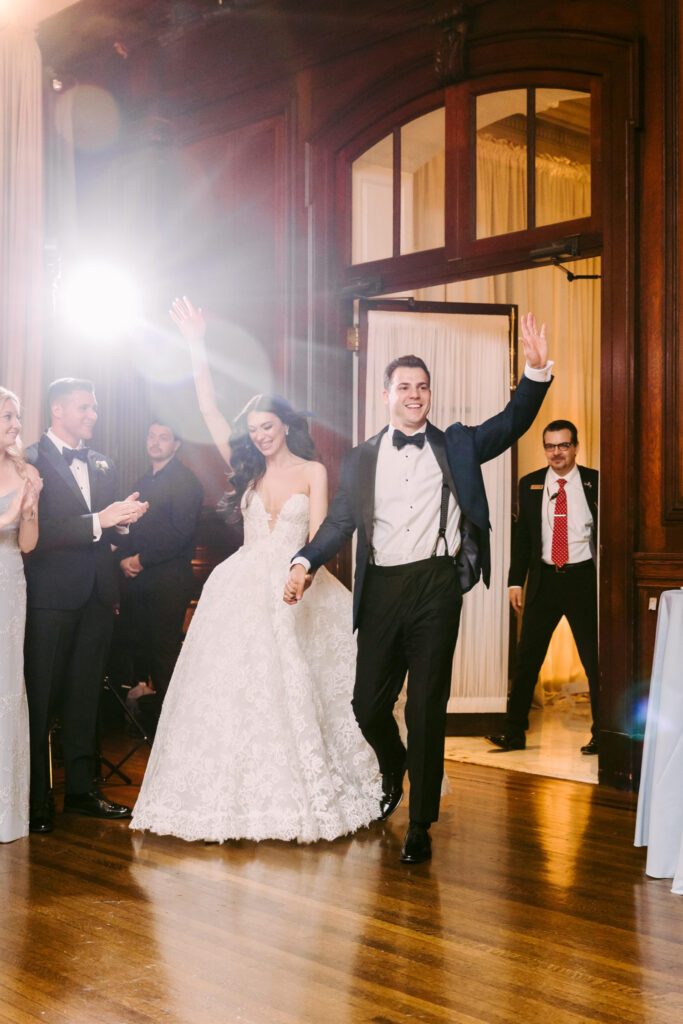 bride & groom entering their wedding reception at The Union League of Philadelphia by Emily Wren Photography