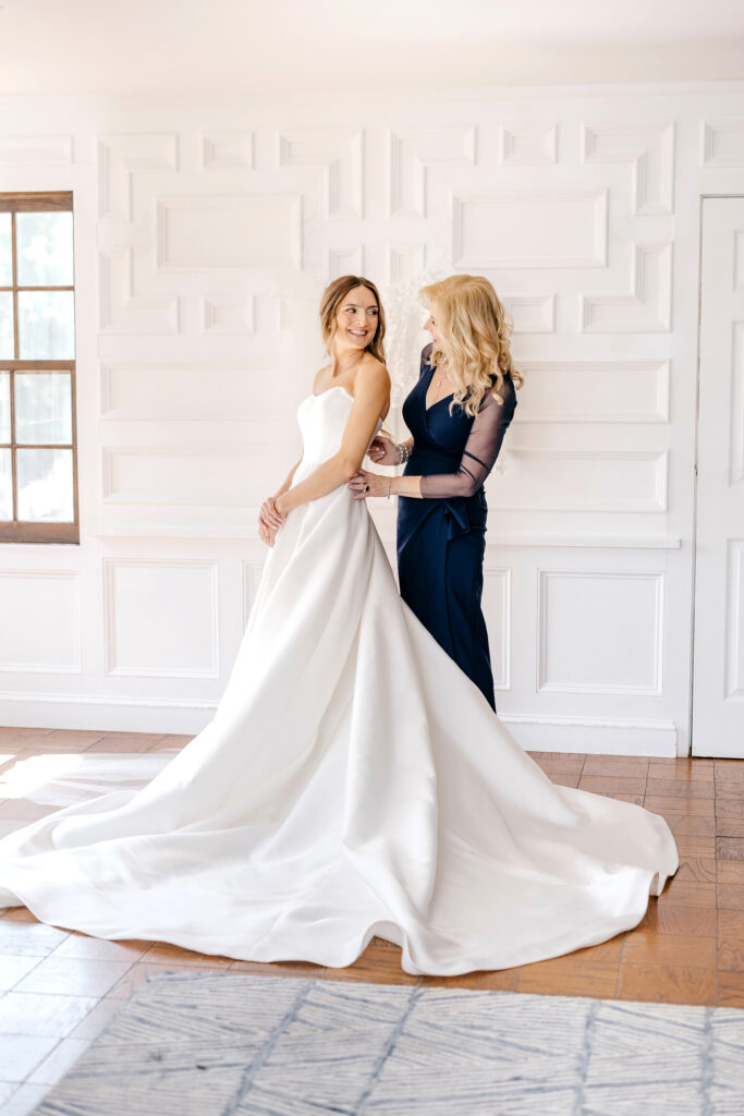 bride getting ready for her Pennsylvania wedding day with her mother by Emily Wren Photography