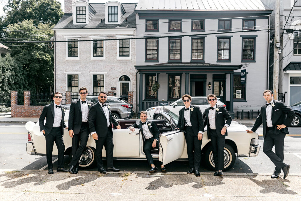 groom with groomsmen in vintage car