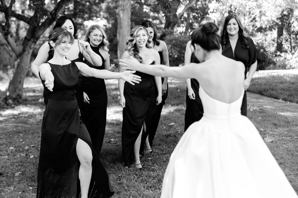 brides first look with her bridesmaids at Grace Winery