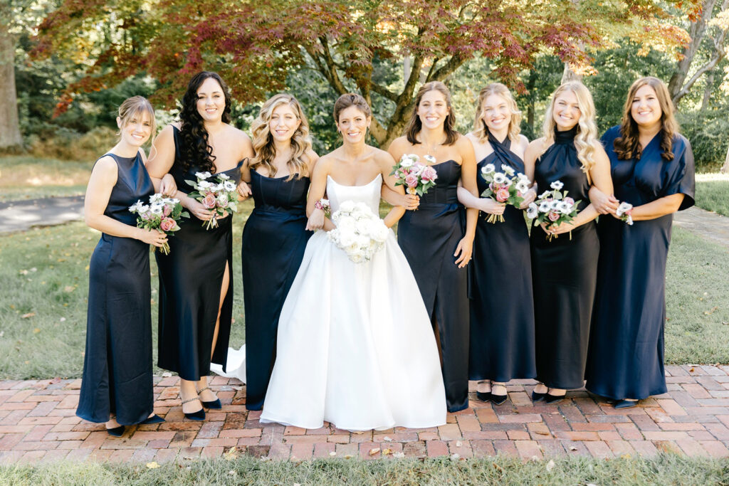 bride with bridesmaids in dark blue bridesmaid dresses