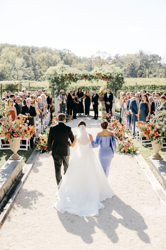 bride walking down the aisle at her outdoor winery wedding ceremony