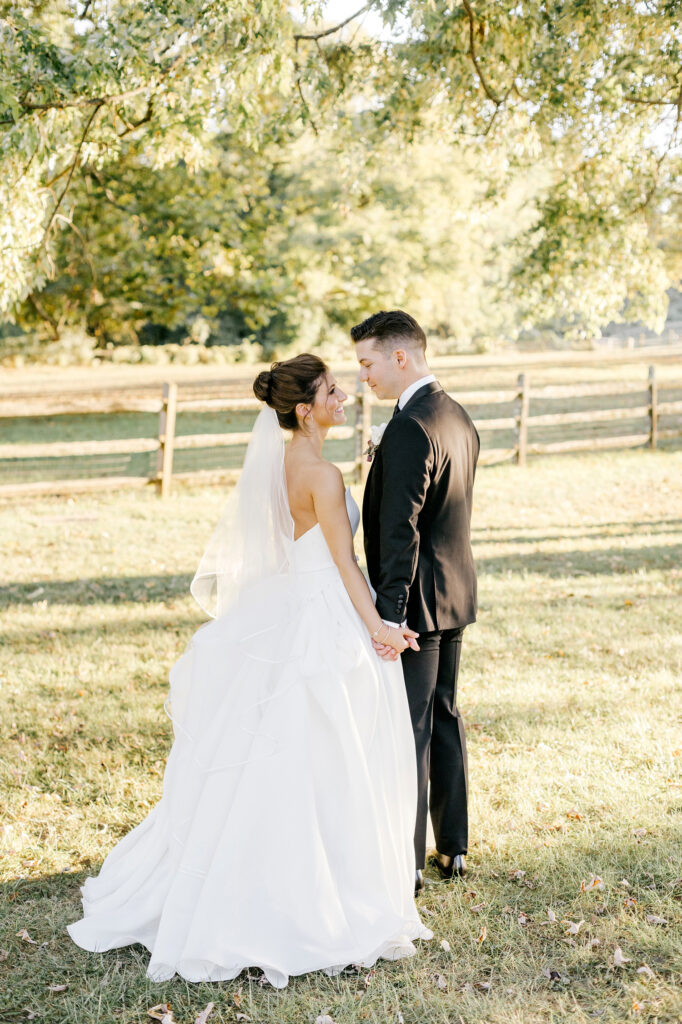 bride and groom walking through winery wedding venue In Glen Mills Pennsylvania