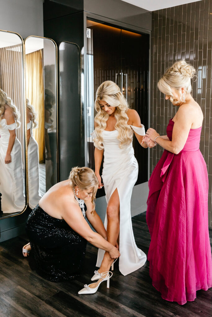 Bride getting ready for her Philadelphia wedding day with her sister and mother