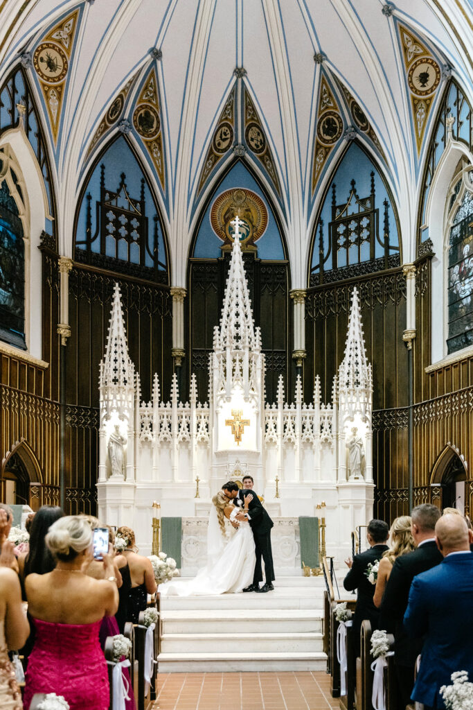 bride and grooms first kiss at Center City Philadelphia church wedding ceremony