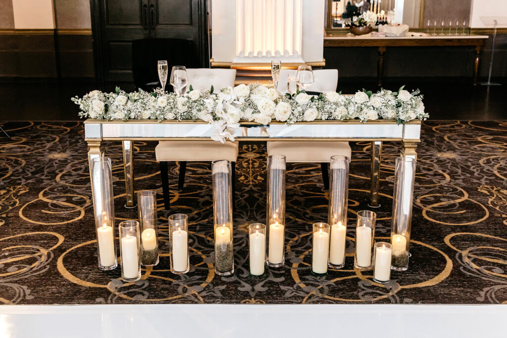 sweetheart table decorated with white roses and babies breath at Philadelphia wedding reception at Ballroom at the Ben