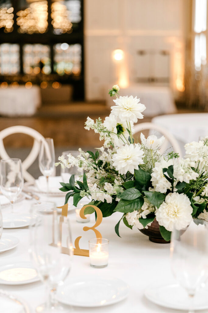 all white floral table decor at The Ivy wedding reception by Emily Wren Photography