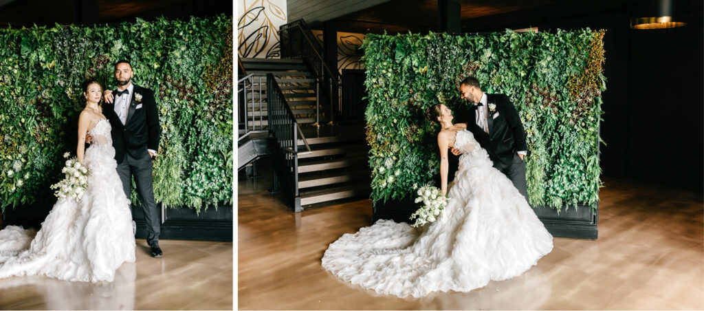 bride and groom in front of greenery photo wall, crafted by Nicol Floral Design at The Ivy at Ellis Preserve