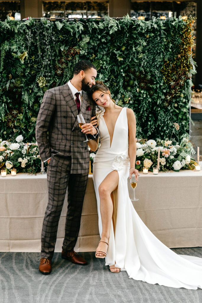 bride dressed in deep V Van Cleve wedding dress and groom in brown plaid tuxedo from Van Cleve