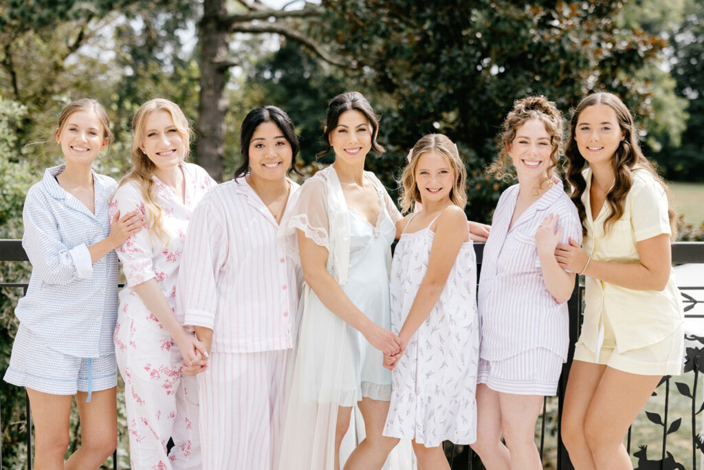 bride with bridesmaids in pastel pajamas by Emily Wren Photography