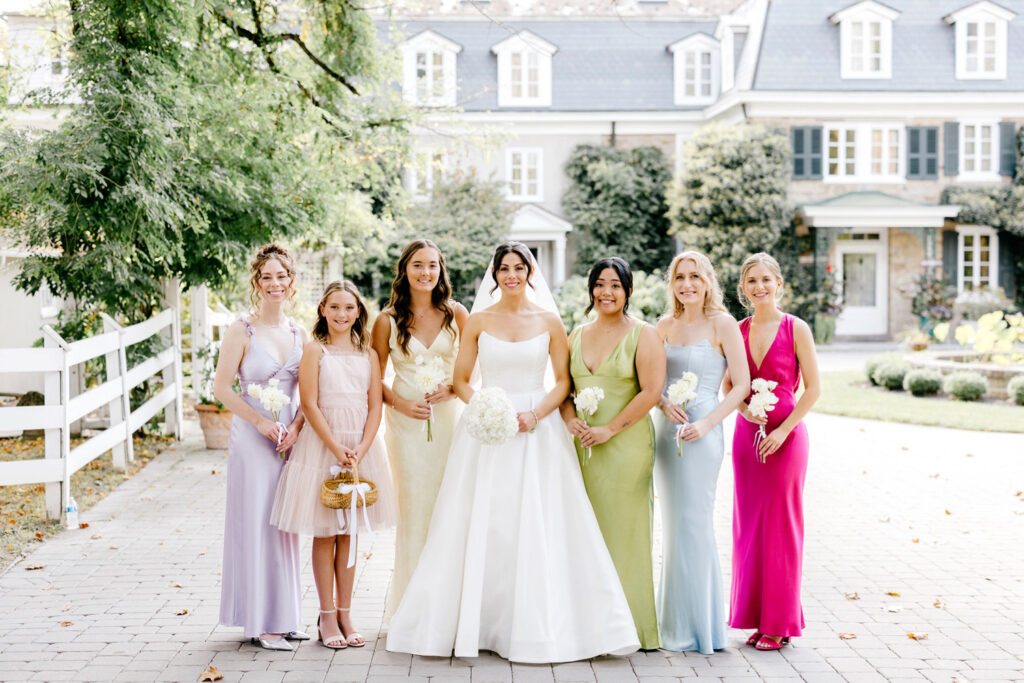 bride with bridesmaids dressed in jewel-colored bridesmaid dresses at The Inn at Barley Sheaf