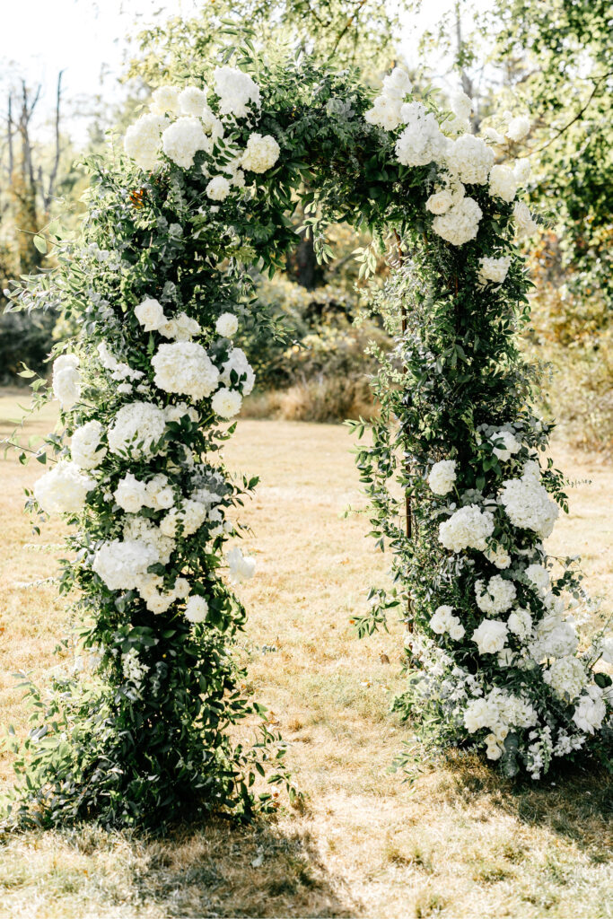 white floral wedding ceremony arch at The Inn at Barley Sheaf