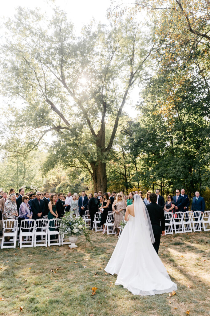 bride walking down the aisle at outdoor wedding ceremony at The Inn at Barley Sheaf by Emily Wren Photography