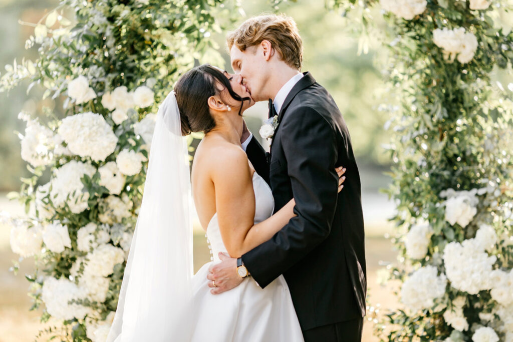 bride and grooms first kiss during their outdoor wedding ceremony in Pennsylvania by Emily Wren Photography