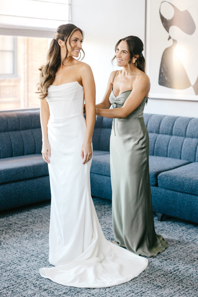 bride getting ready for her Philadelphia wedding day with her maid of honor