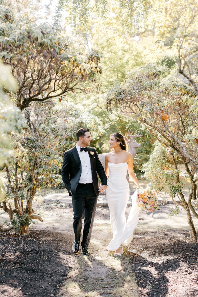 bride and groom walking through Philadelphia garden