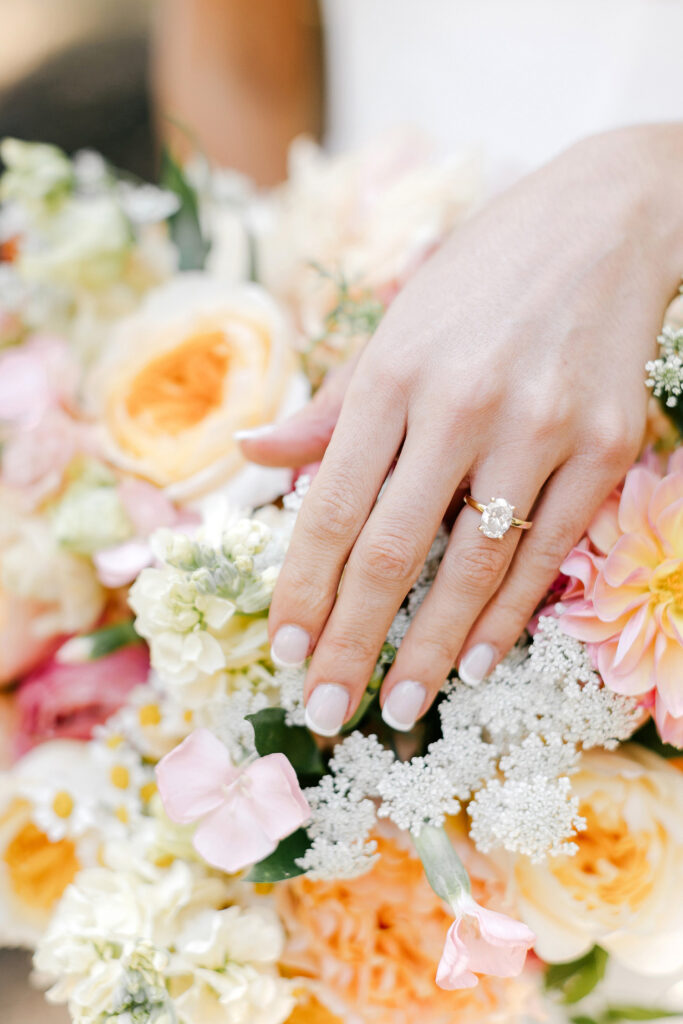 brides engagement ring against her bridal bouquet