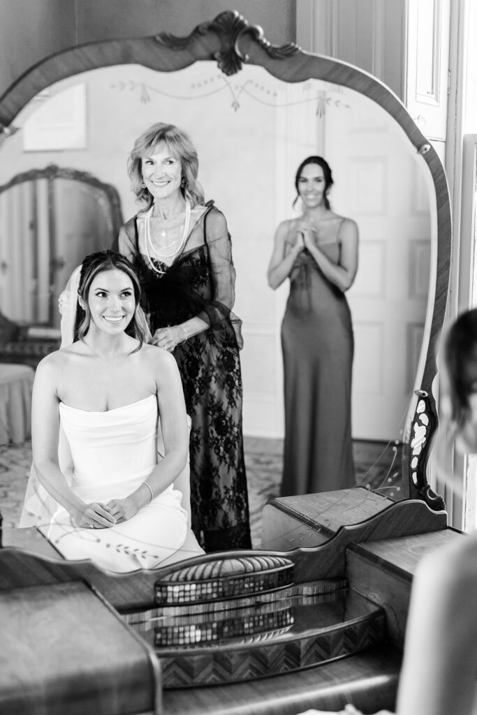 mother of the bride putting the veil on her daughter by Emily Wren Photography