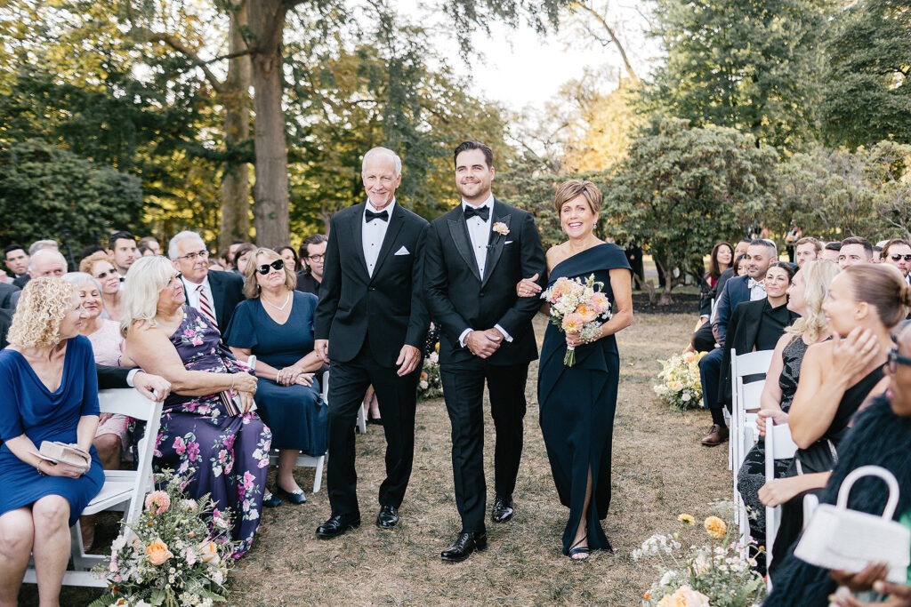 groom walking down the aisle at his outdoor Philadelphia wedding ceremony