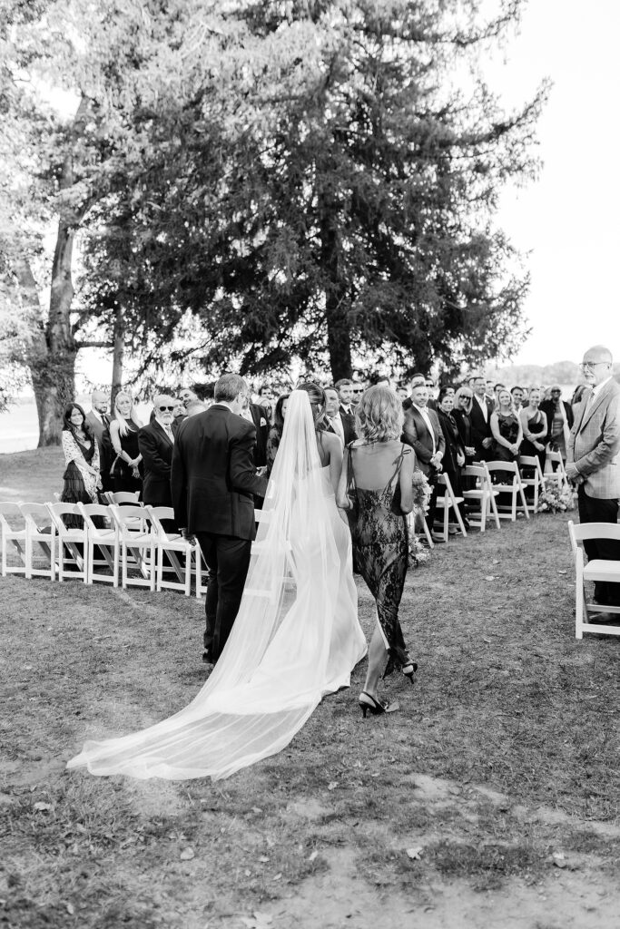 bride walking down the aisle at outdoor fall Philadelphia wedding ceremony along the river