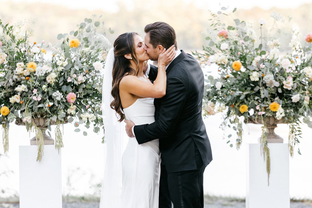 bride and grooms first kiss at their outdoor Glen Foerd wedding ceremony