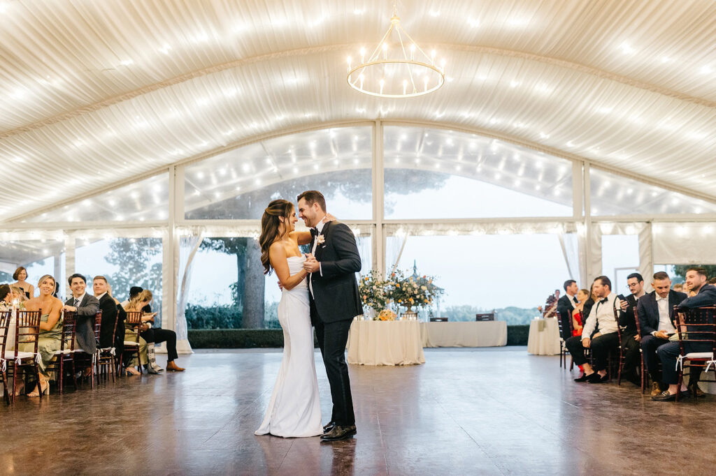 bride & grooms first dance at their Glen Foerd wedding reception under a white tent with fairy lights