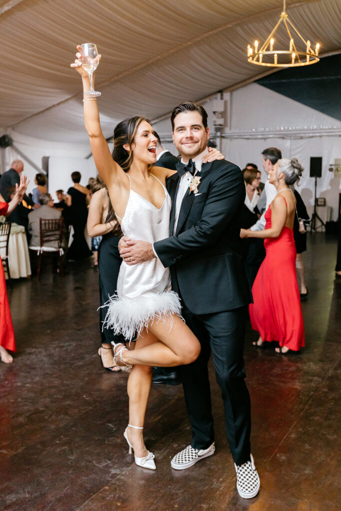 bride and groom having fun at their white tent wedding reception at Glen Foerd