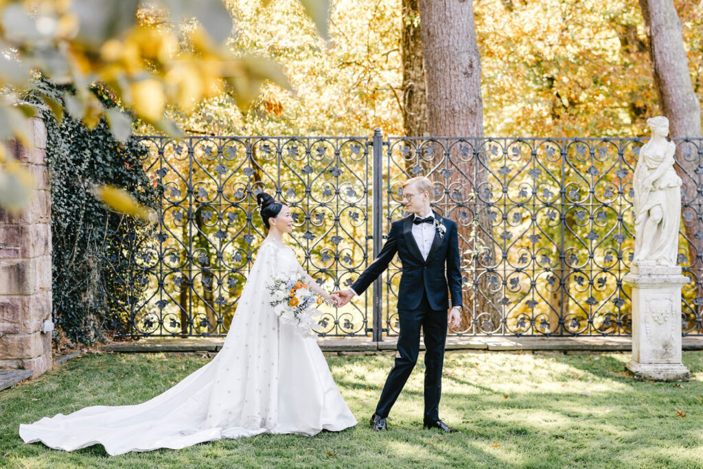 bride and groom walking through New Jersey garden