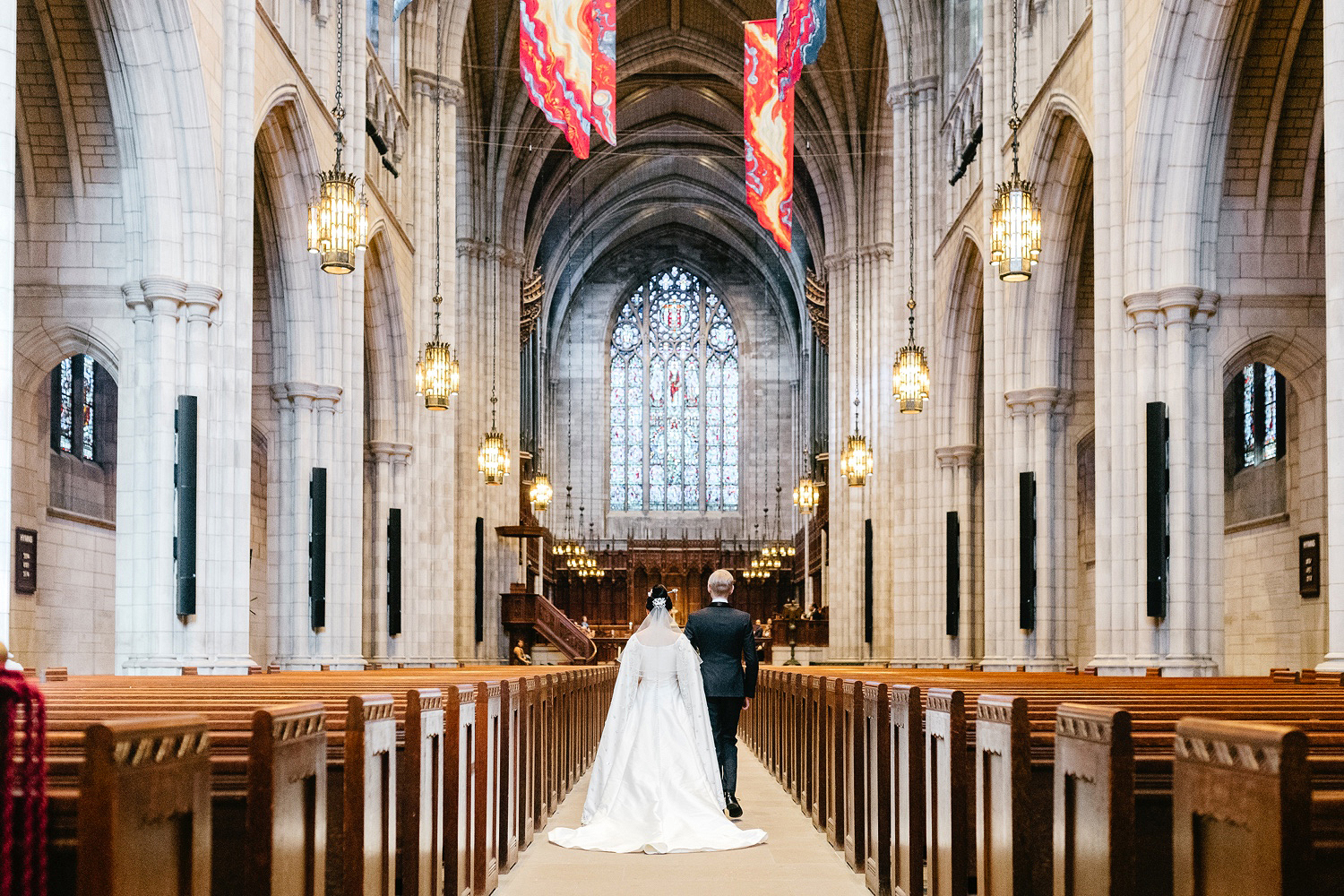 bride and groom walking down the aisle together at Princeton University Chapel