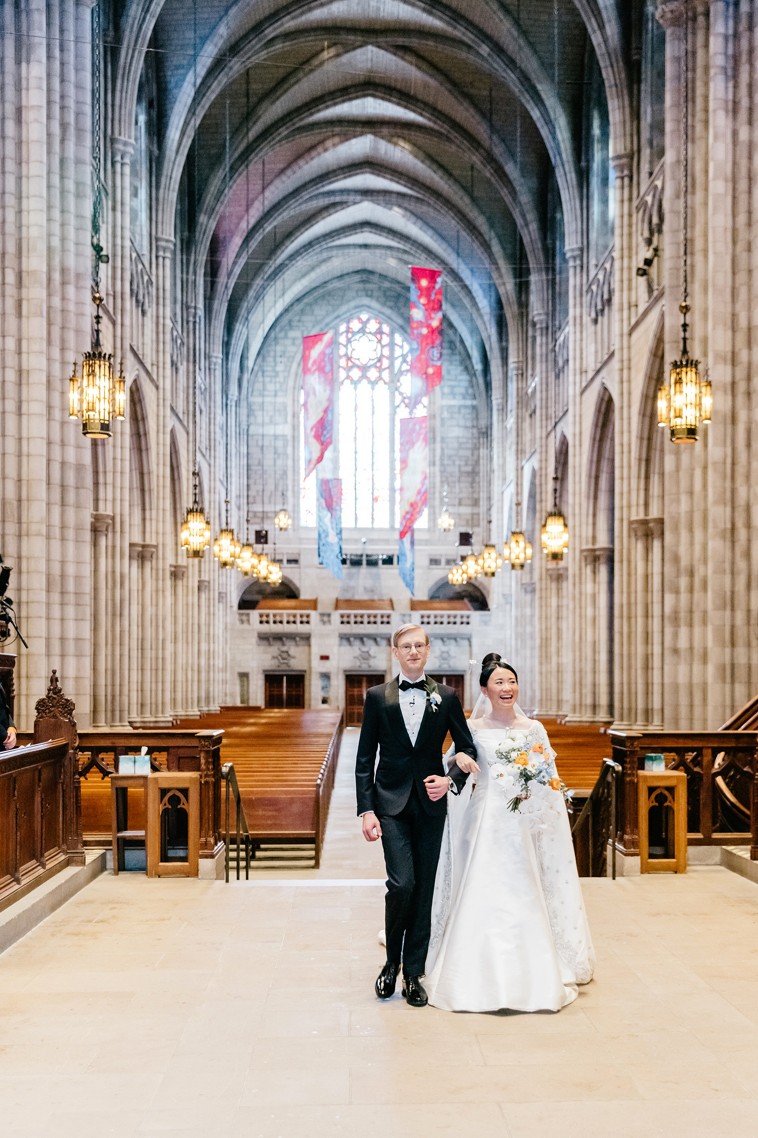 bride & groom walking down the aisle together at their Church wedding ceremony