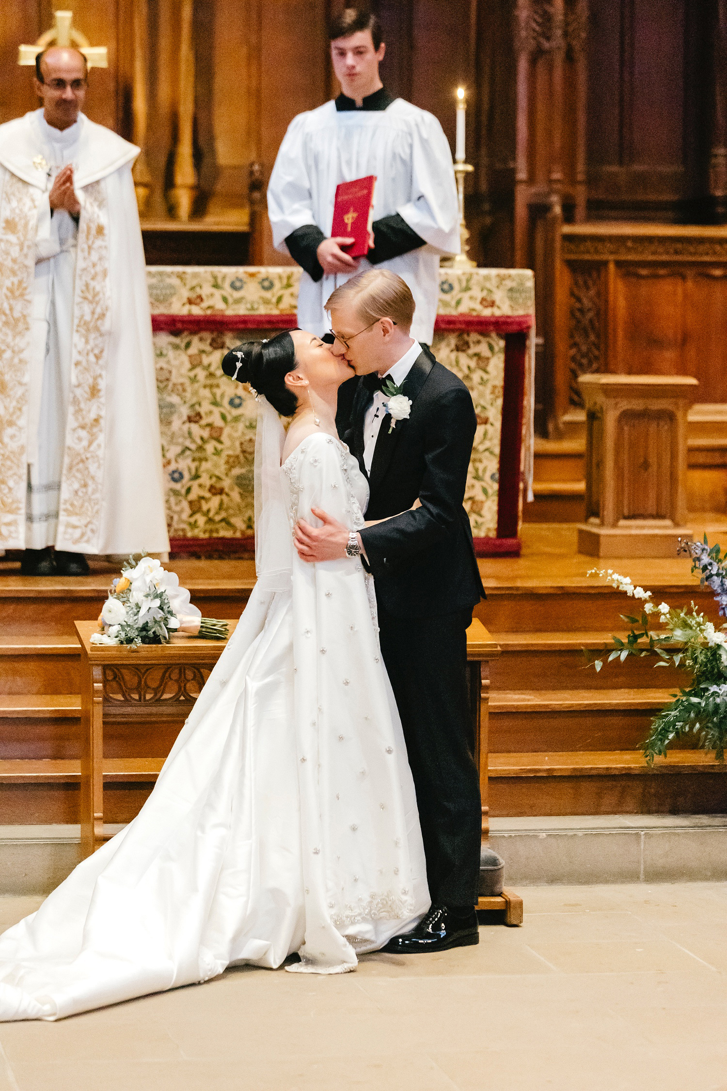 bride & grooms first kiss at Princeton University Chapel wedding ceremony by Emily Wren Photography