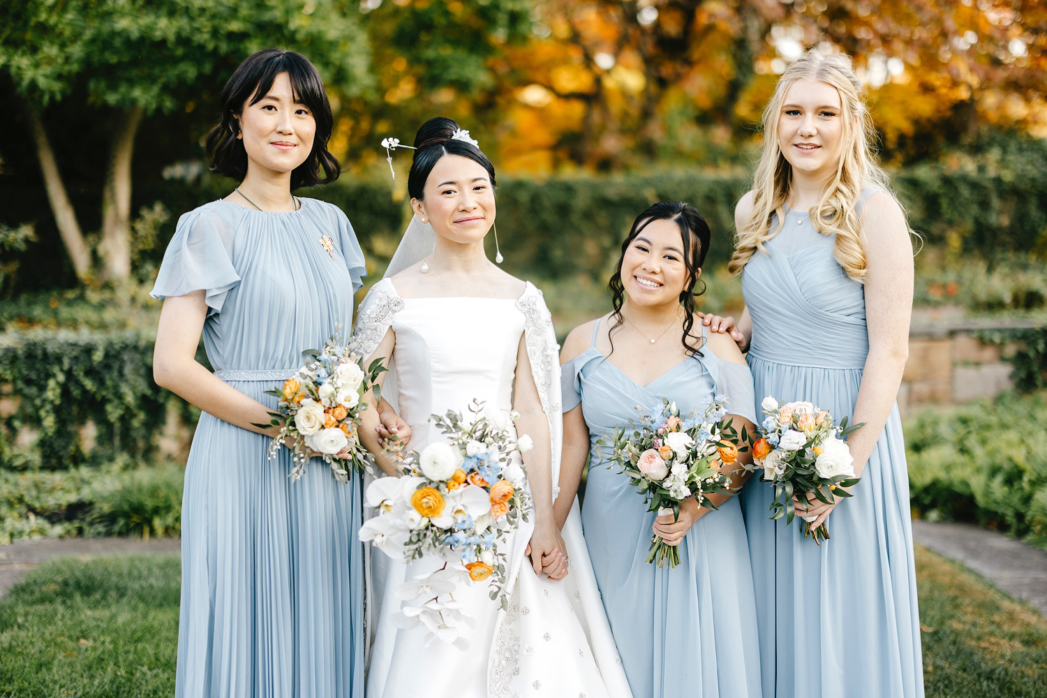 bride with bridesmaids in light blue bridesmaid dresses on fall wedding day in New Jersey