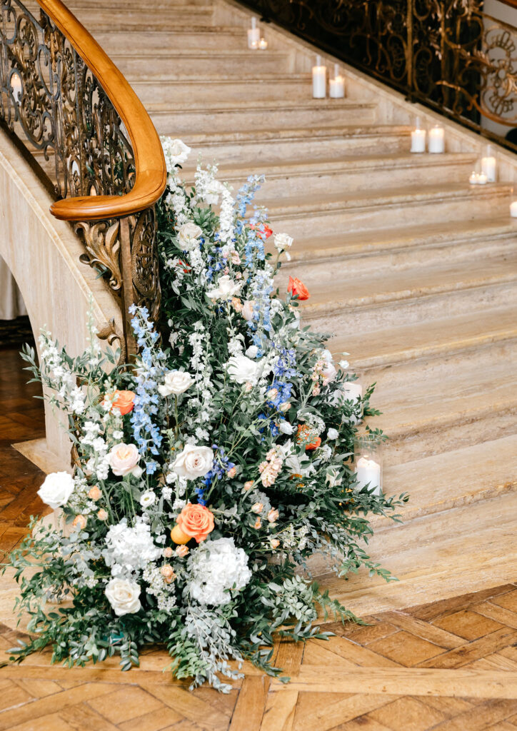 blue white and orange fall floral stair display by Ivy on Main Florals at Jasna Polana