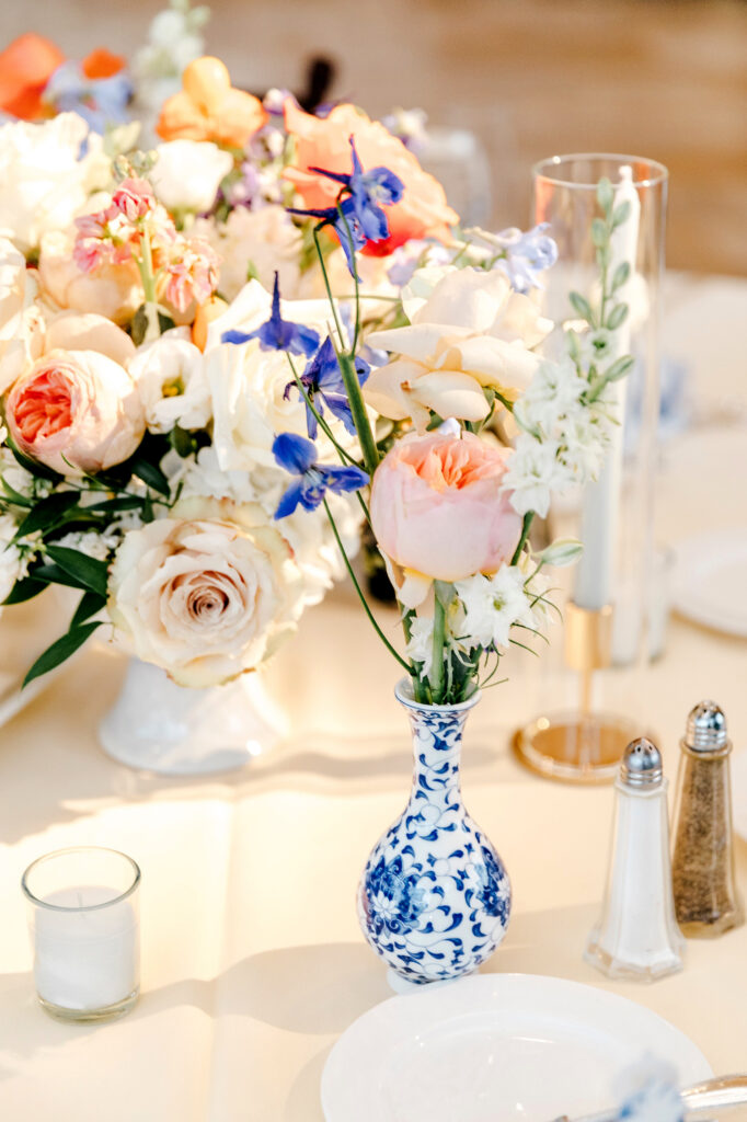 white, blue and pink wedding reception table florals