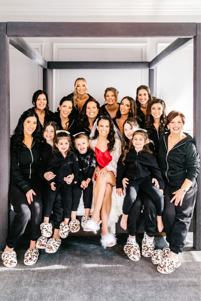 Philadelphia bride with her bridesmaids and flower girls in matching black sweatsuits