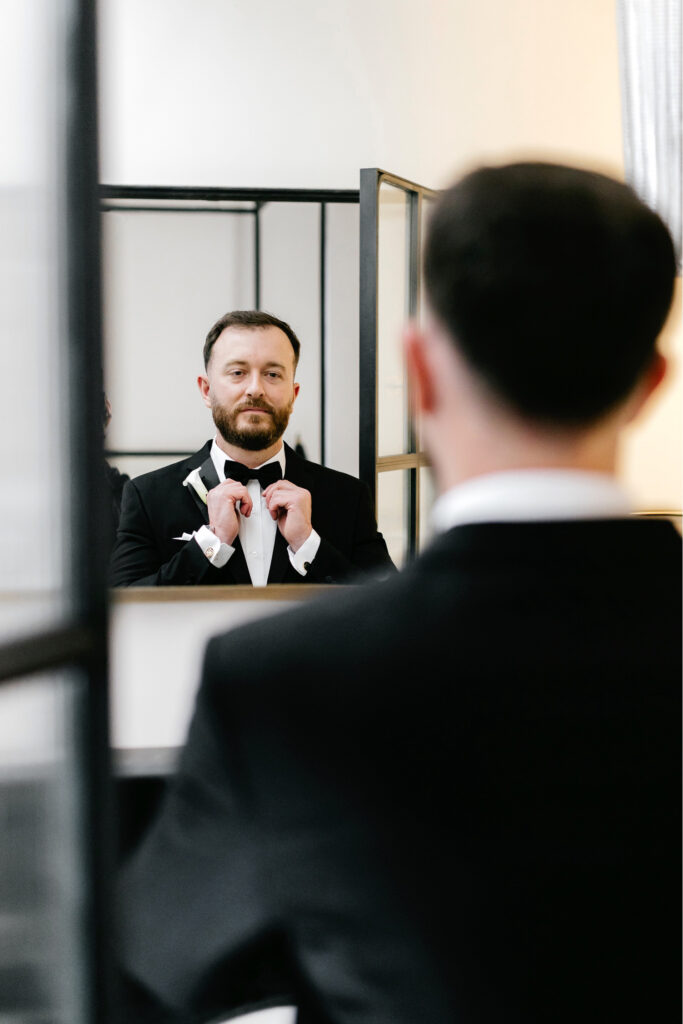 groom getting ready for his winter wedding day at the Bellevue Hotel by Emily Wren Photography