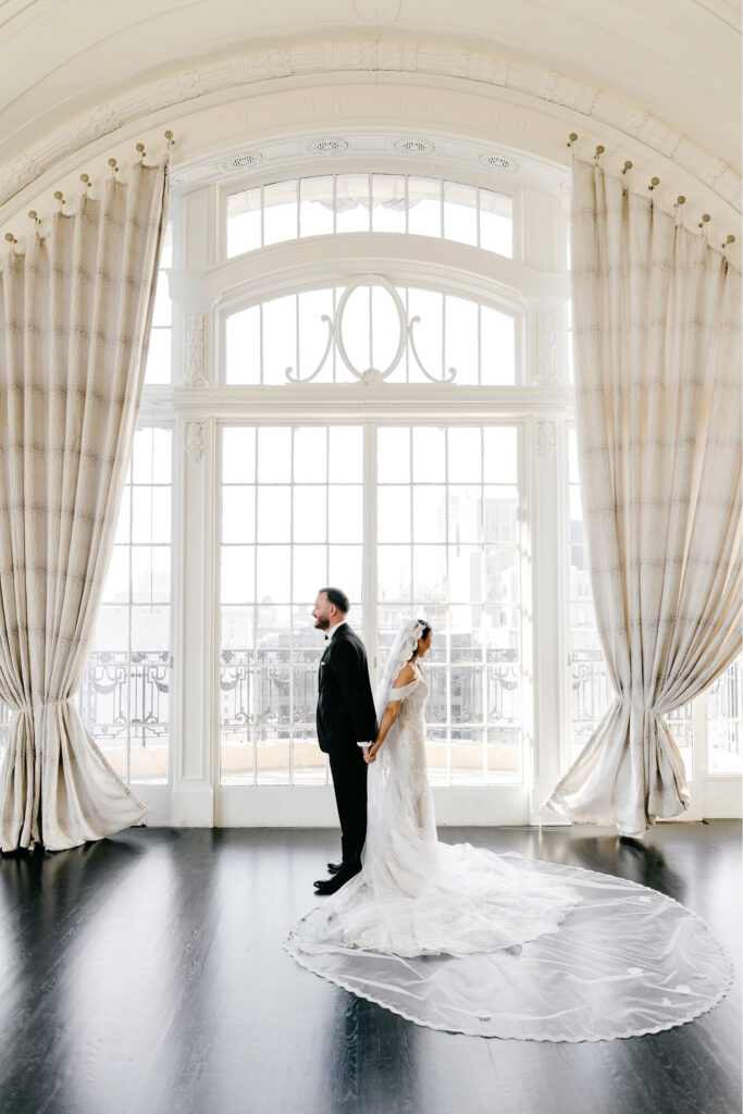 bride & groom's first touch at Bellevue Hotel by Emily Wren Photography