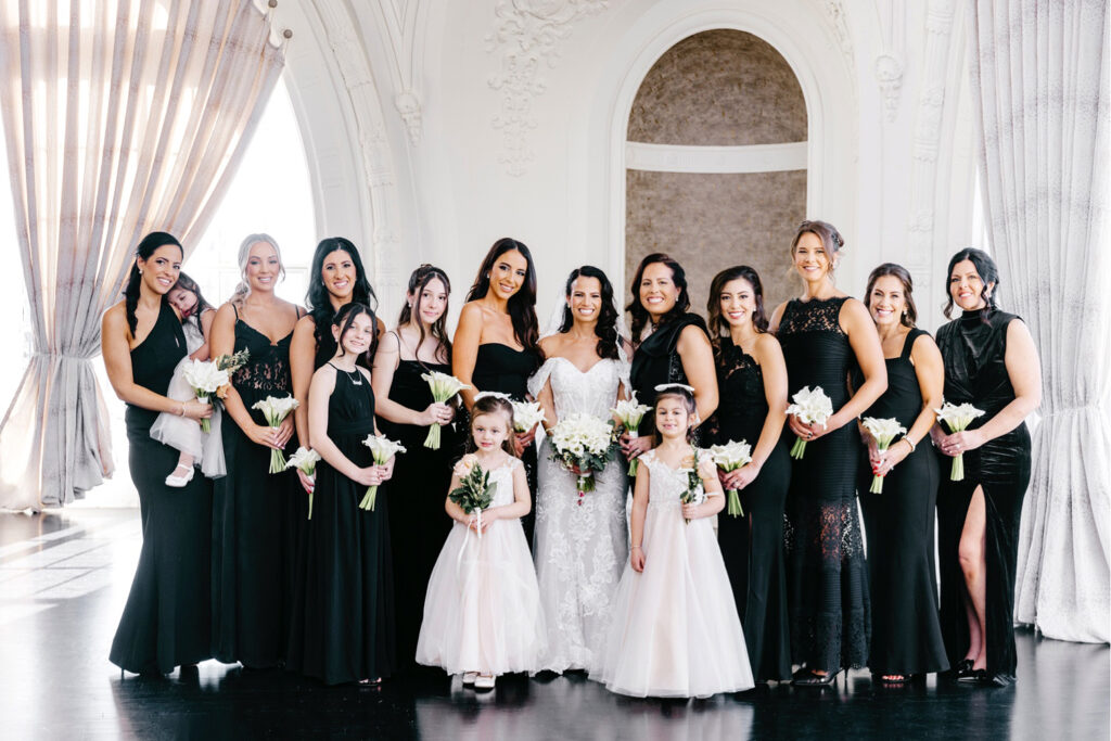 bride with her bridesmaids in black bridesmaid dresses by luxurious wedding photographer Emily Wren Photography