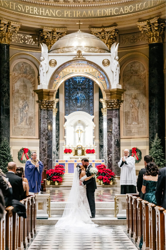 bride & grooms first kiss at their wedding ceremony at Cathedral Basilicia in Philadelphia