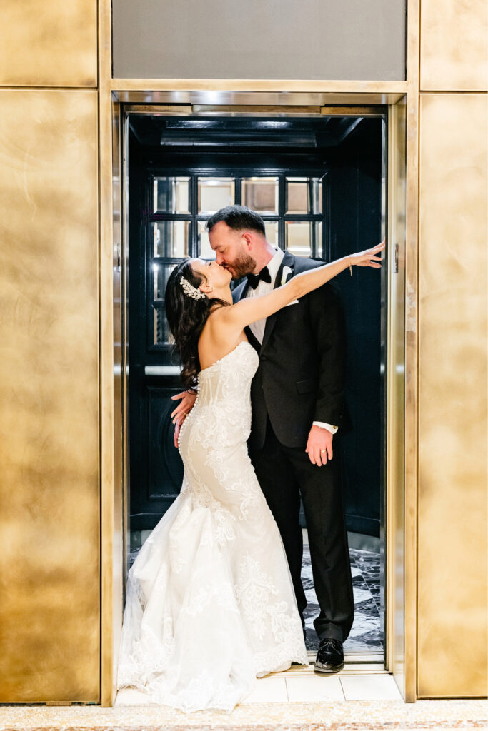 bride & groom kissing in elevator wedding day portrait by Emily Wren Photography