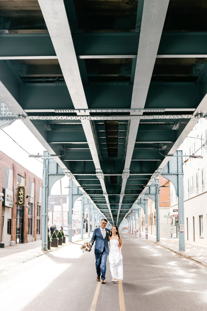 wedding portraits of bride and groom under the el in Philadelphia by Emily Wren Photography