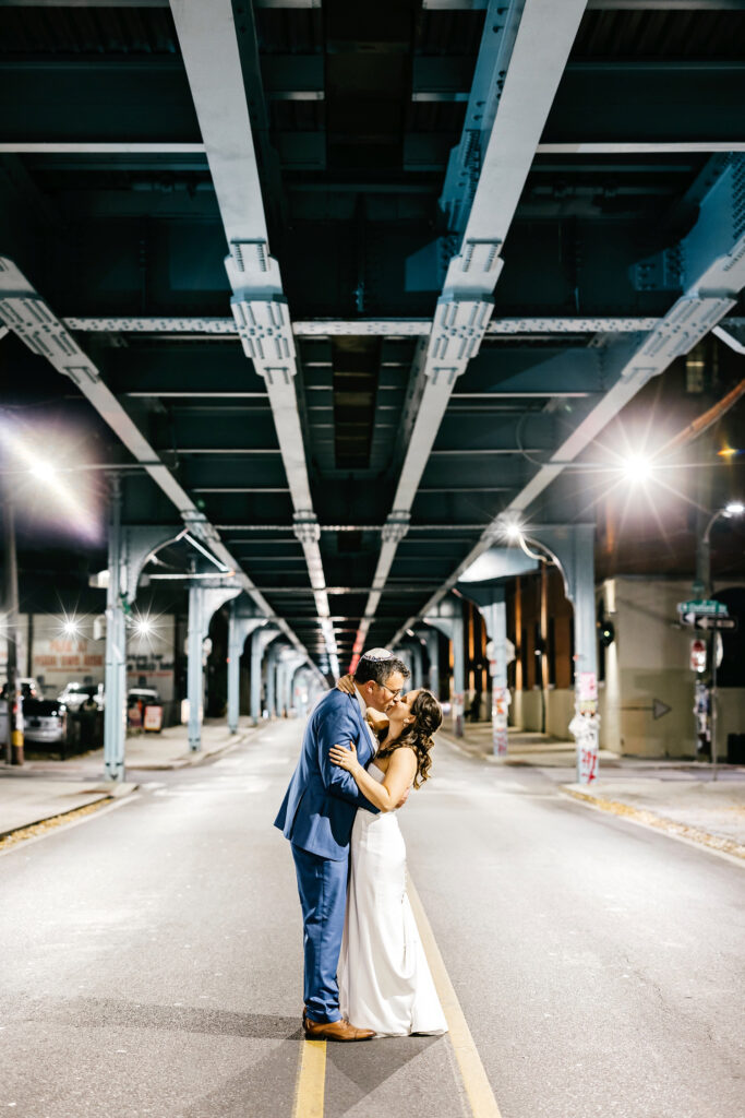 bride & groom night portrait under the el in Fishtown in Philadelphia by Emily Wren Photography