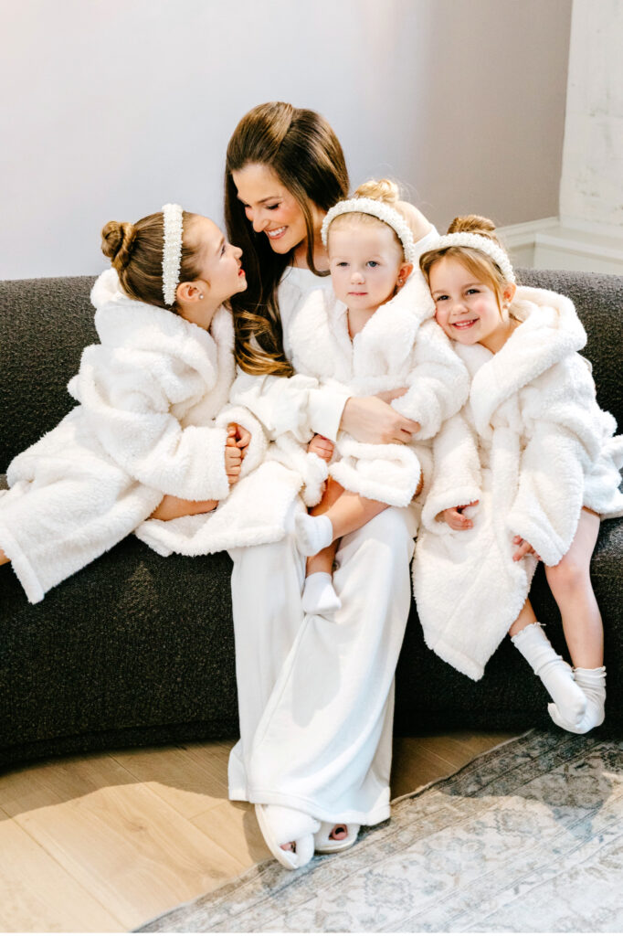 bride with her flower girls in matching white robes by Emily Wren Photography