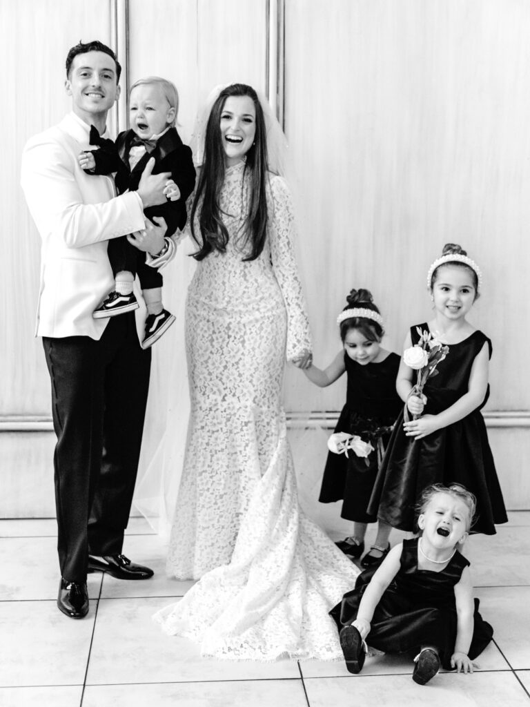 bride and groom with flower girls funny portrait