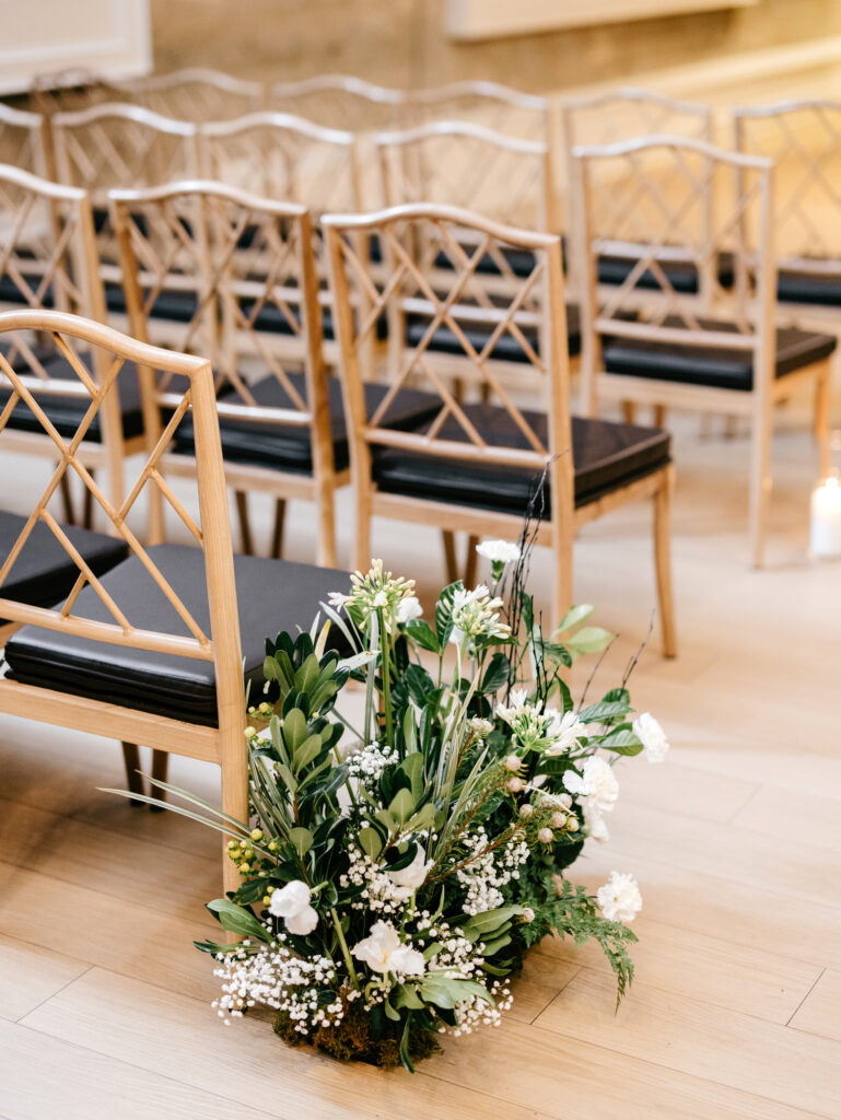 white bouquets lining the aisle at Philadelphia winter wedding ceremony