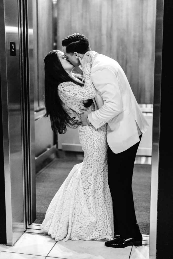 bride and groom kissing in an elevator at The Switch House by Emily Wren Photography